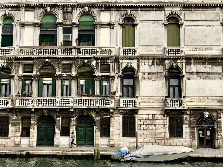 person jogging near white boat docking near building, white motorboat near white concrete building at daytime HD wallpaper