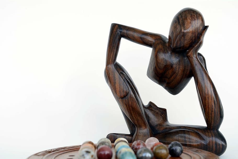 brown human statue near on marble ball toy collection, thinker