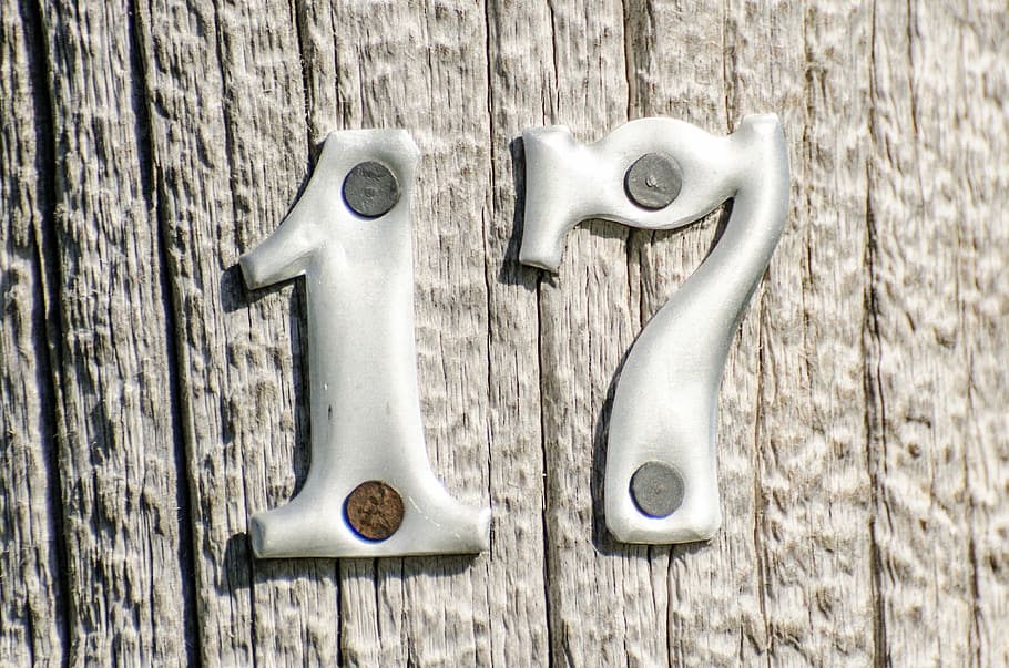 gray 17 signage, numbers, metal numbers on post, wooden post