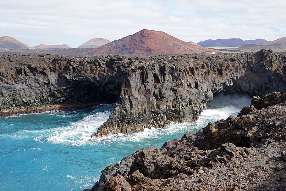 body of water beside black rocky cliff, los hervideros, lanzarote HD wallpaper