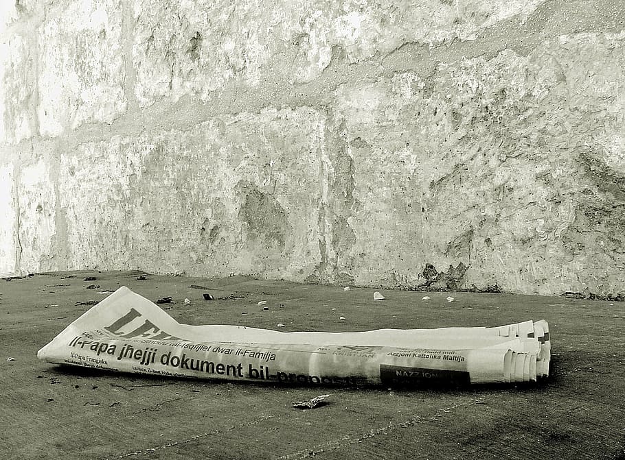 newspaper on gray concrete floor, yesterdays news, discarded