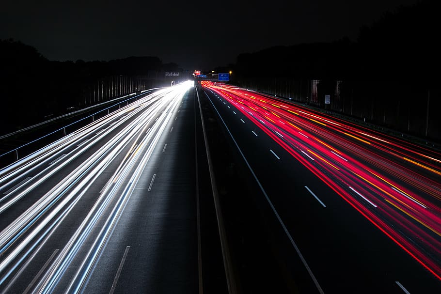 time lapse photography of vehicle passing on road during nighttime HD wallpaper