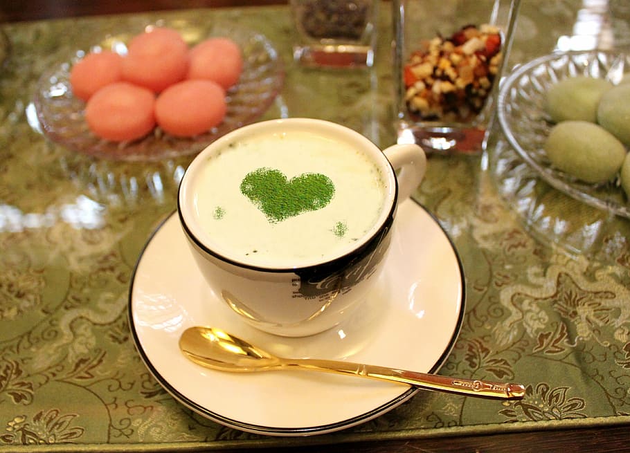 white drink garnished with green powder placed on white ceramic teacup HD wallpaper