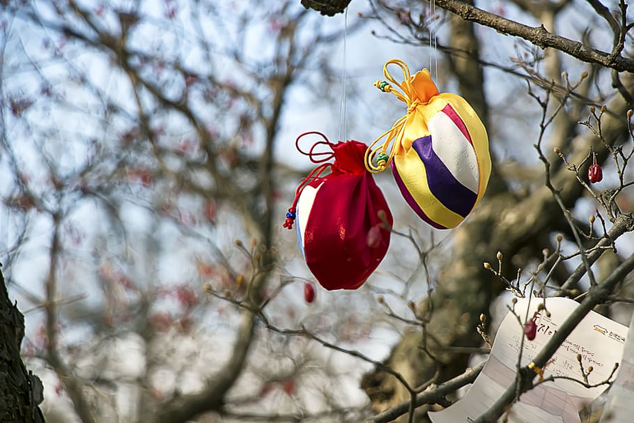 two red and yellow hanging drawstring pouches, korean folk village