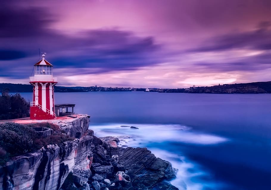 red and white lighthouse near body of water under cloudy sky, HD wallpaper