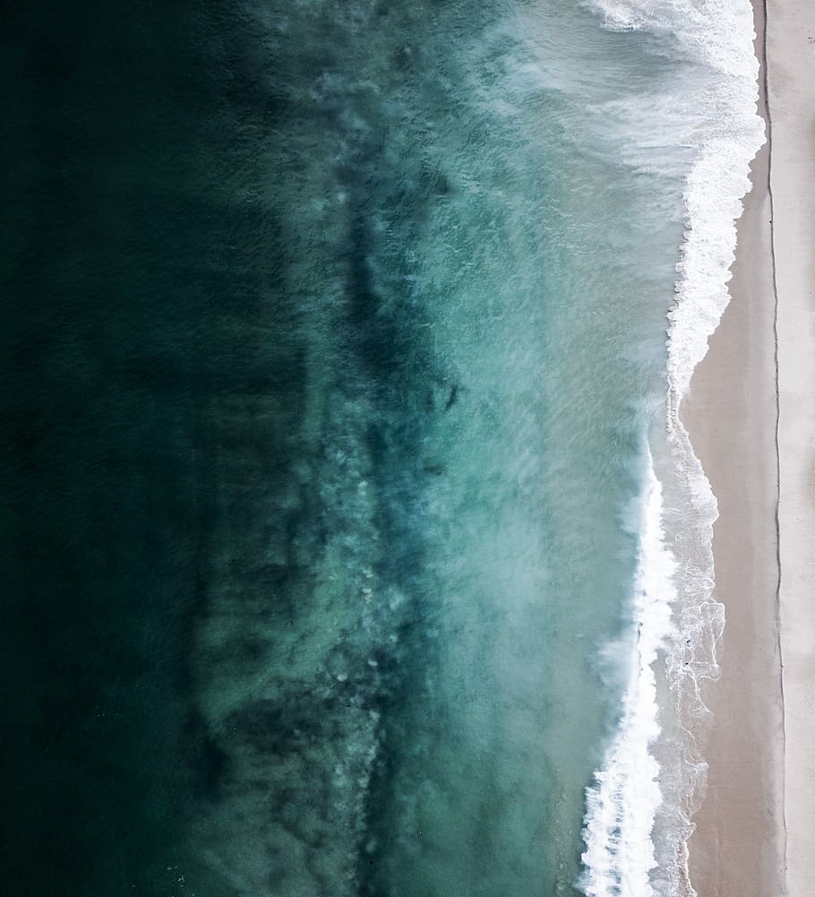 aerial view of beach shore during daytime, calm body of water