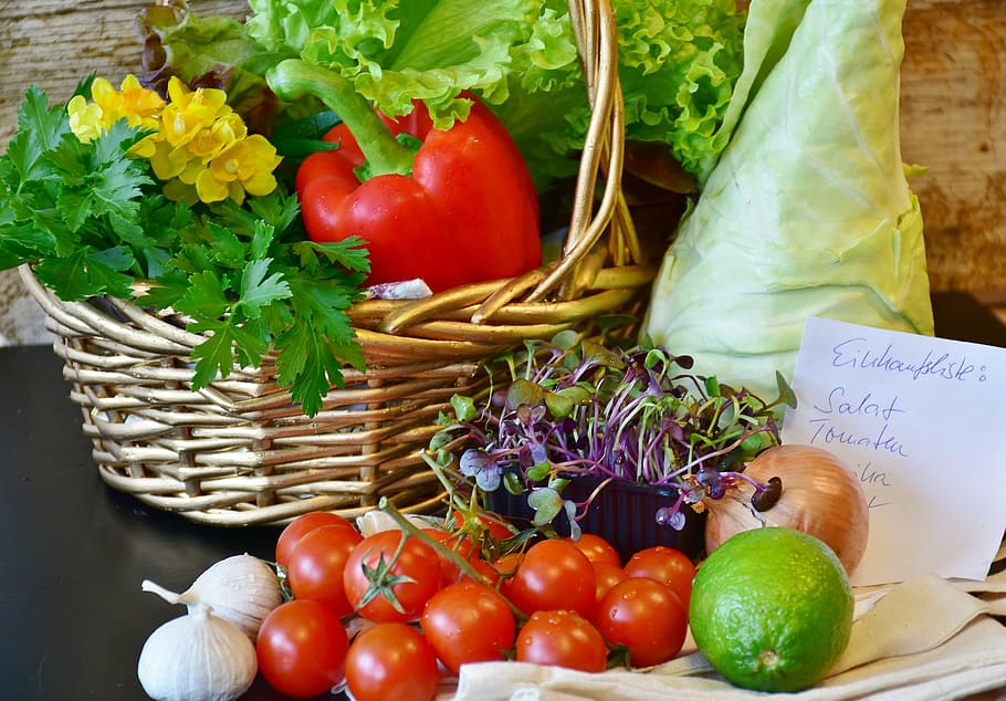 assorted-color fruits inside basket on black table, vegetables
