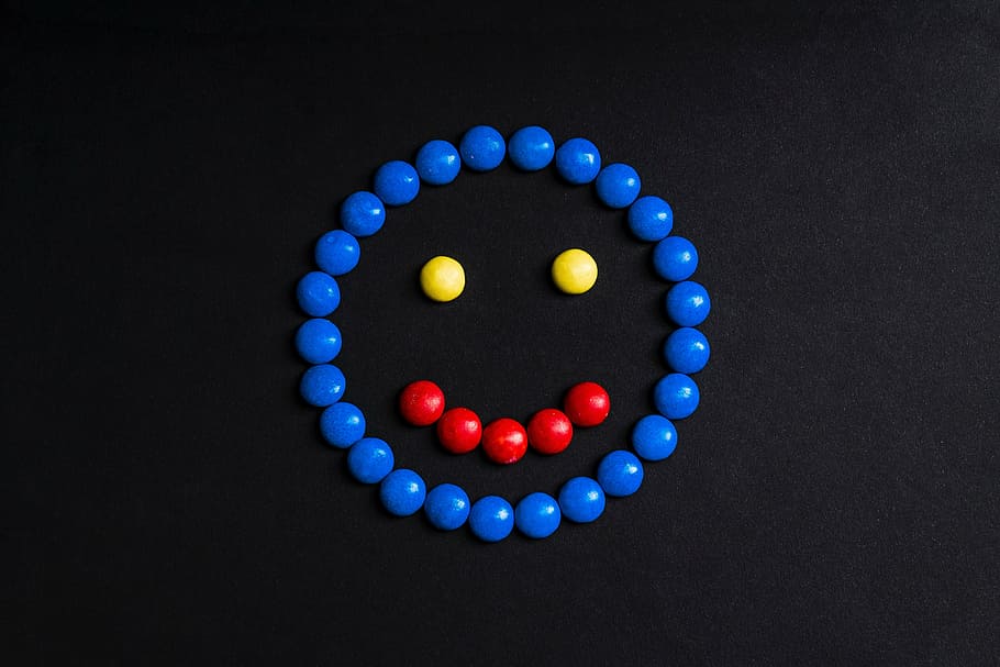 red, yellow, and black smiling emoji on black surface, colorful, HD wallpaper