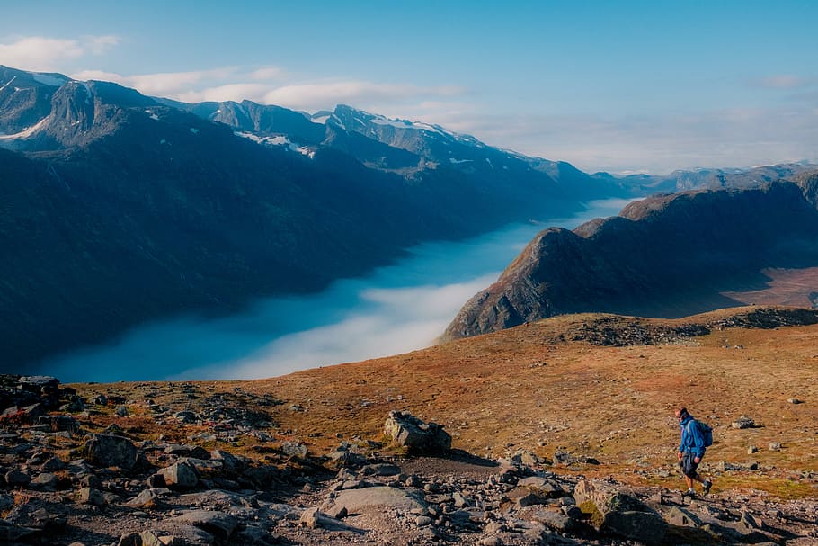 person walking on mountain, person walking on mountain during daytime HD wallpaper