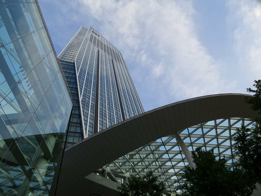 low-angle photography of high-rise glass building under white clouds and blue sky HD wallpaper