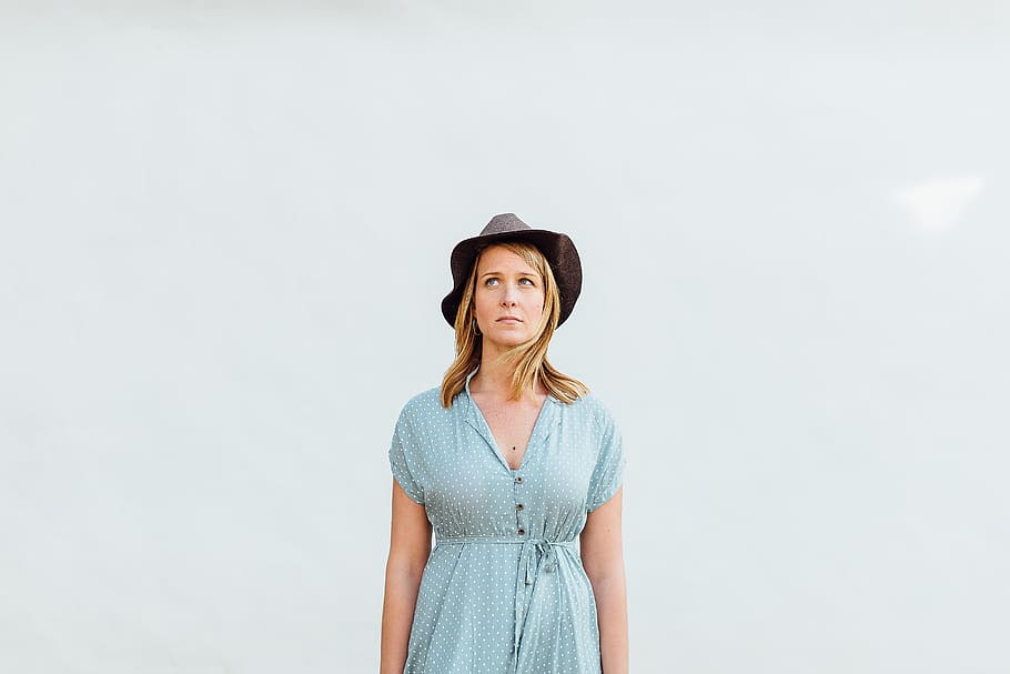 woman standing infront of wall, people, female, girl, hat, clothing