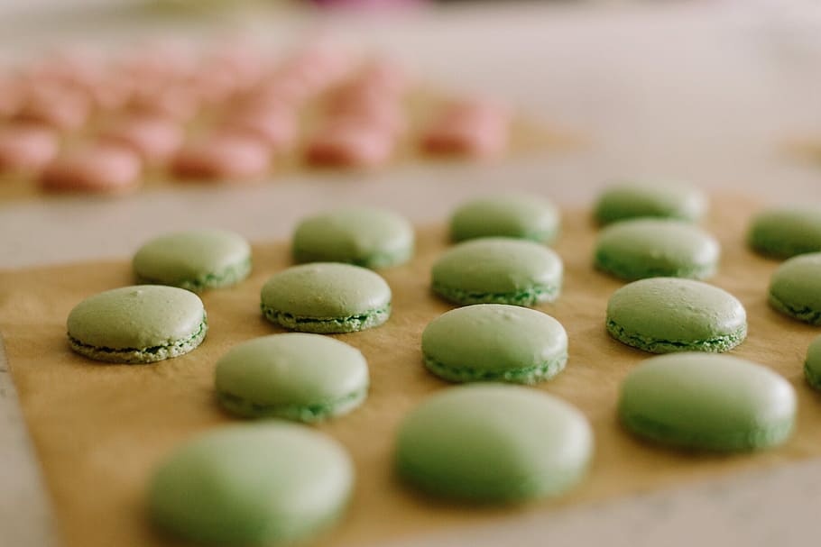 several pastries on brown board, green and pink macarons lot HD wallpaper