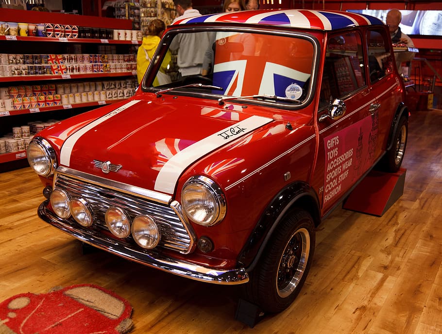 classic red MINI Cooper 3-door hatchback parked inside the store