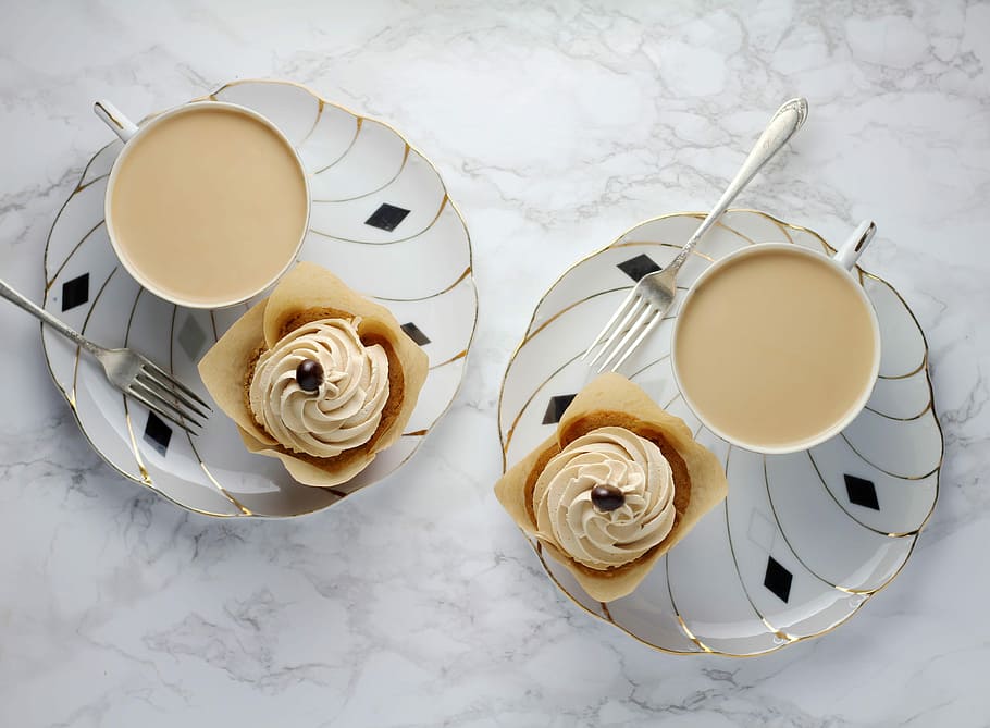 flat lay of photography coffee cups on white plates, two cups of coffee with cupcakes HD wallpaper