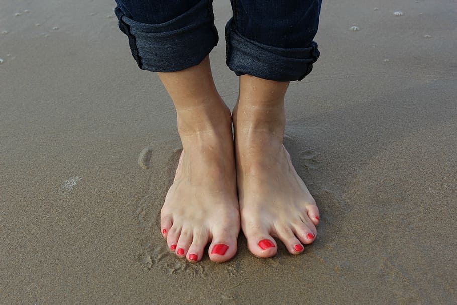 person standing on brown wet sand, beach, holiday, wellness, feet