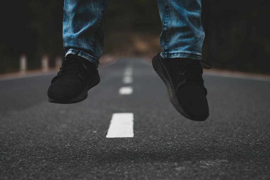 man jumping in the middle of the road, person wearing black sneakers, HD wallpaper