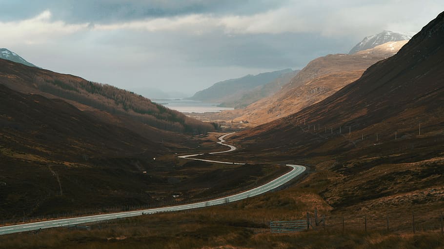 concrete road surrounded by mountains, panoramic photography of highway between mountains HD wallpaper