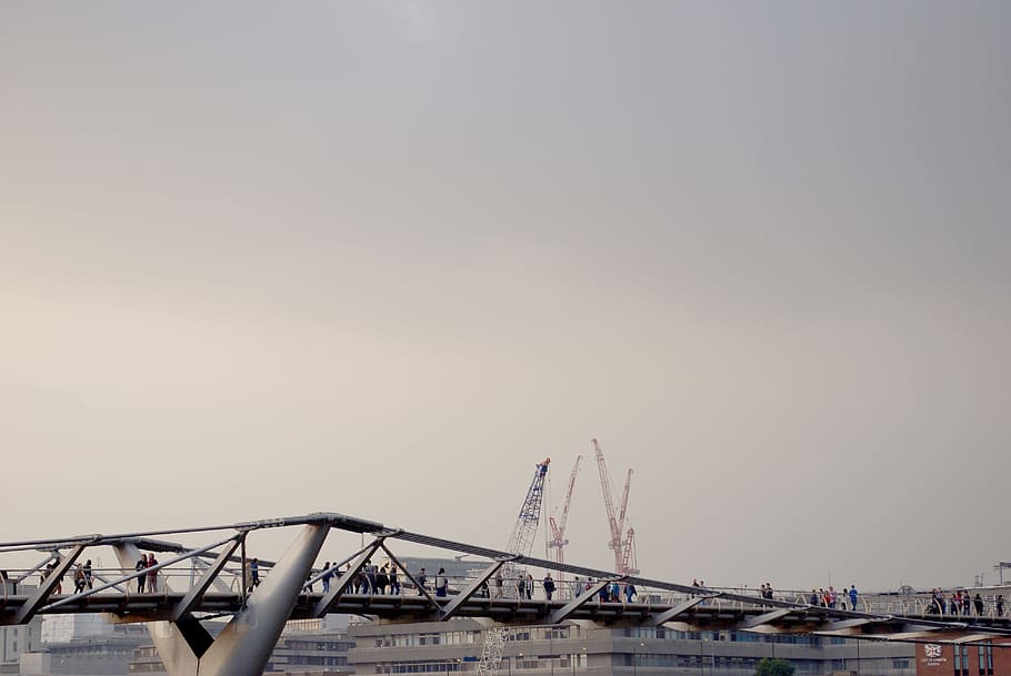 people on bridge, gray metal bridge near crane machine at daytime HD wallpaper