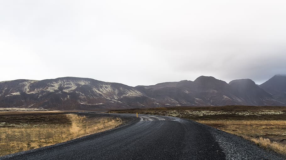 landscape photography of black asphalt pavement near brown mountains under gray sky, black asphalt road under gray clouuds HD wallpaper
