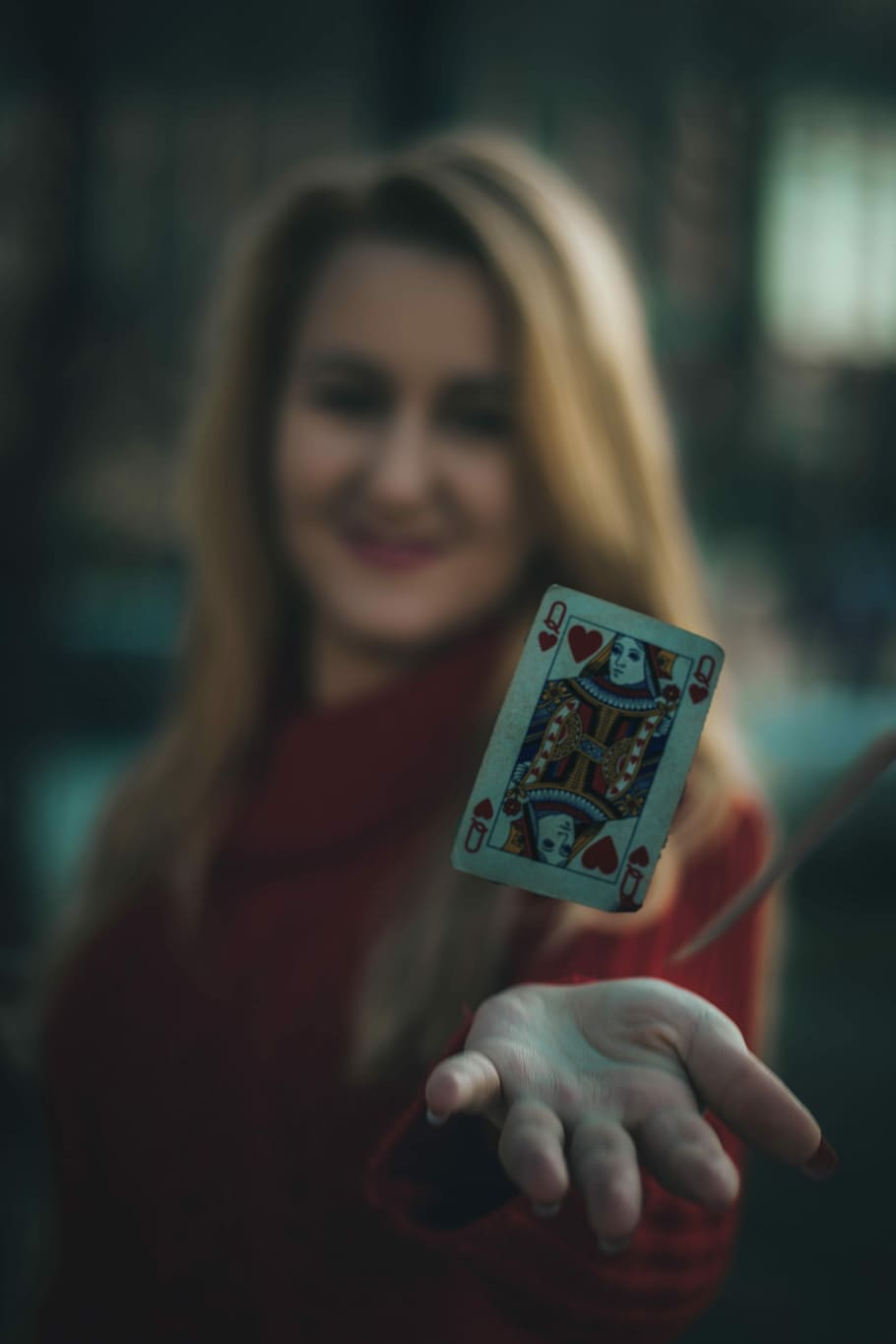 time lapse photo of queen of hearts playing card near woman's palm, queen of hearts floating over person's hand HD wallpaper