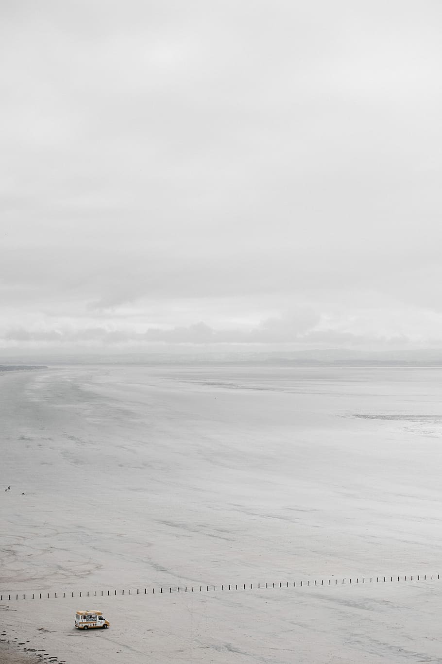 white and yellow RV on seashore under white sky during daytime, bird's eye view photography of white vehicle near seashore HD wallpaper