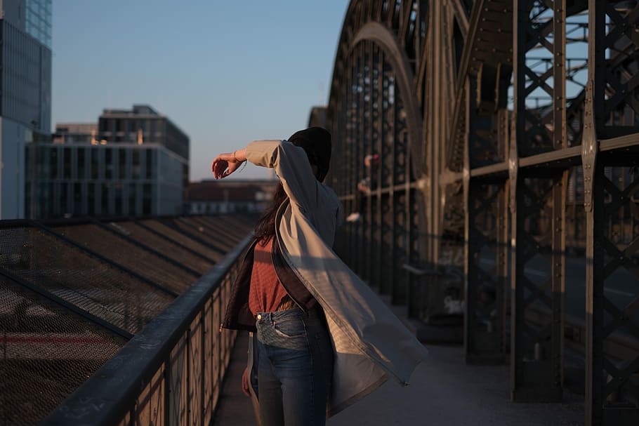 woman standing beside brown steel handrail, woman standing on bridge HD wallpaper