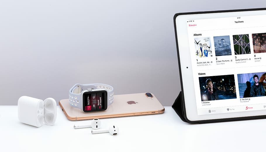 silver iPad near white Apple AirPods, white smartwatch near iPad mini