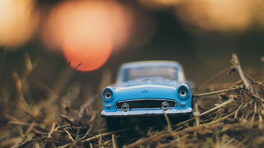 blue toy car on brown grass, selective bokeh photography of classic blue car scale model, HD wallpaper
