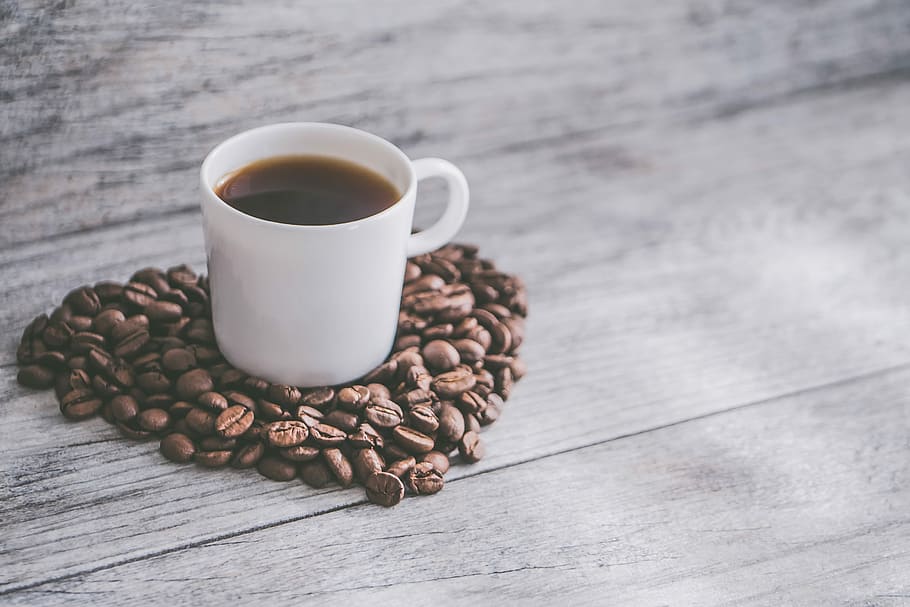 cup of coffee on coffee beans, white ceramic mug with coffee surrounded by coffee beans HD wallpaper