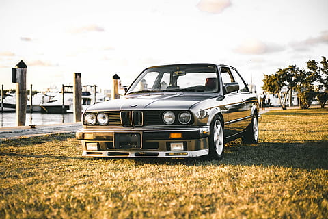 black BWM car on green lawn grass, black BMW sedan parked, field HD wallpaper