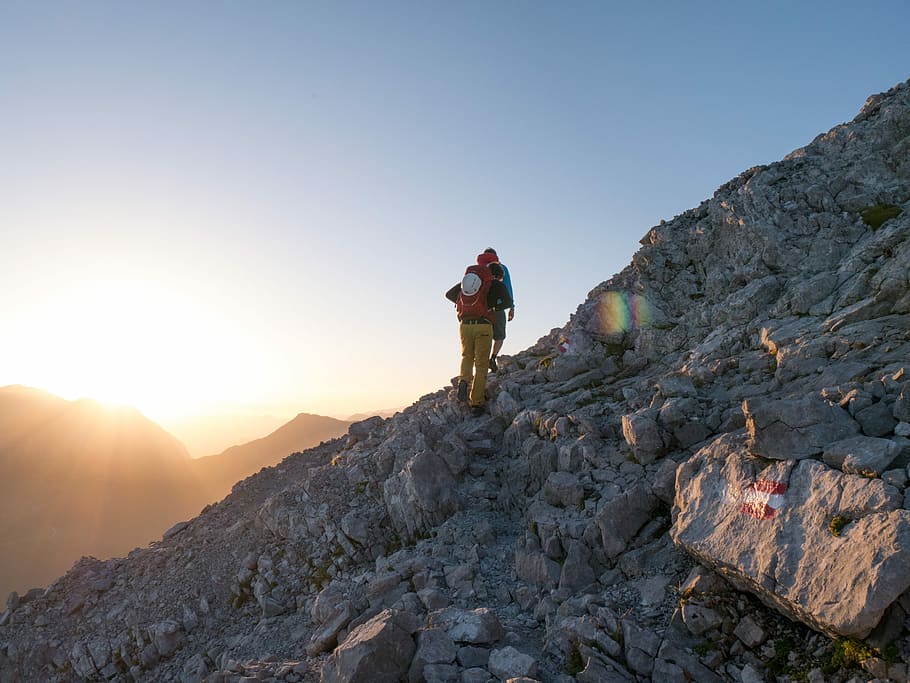 person climbing on mountain, person walking on rocky mountain HD wallpaper