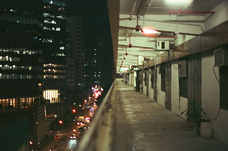 selective focus photography of handrails, high-rise buildings at nighttime HD wallpaper