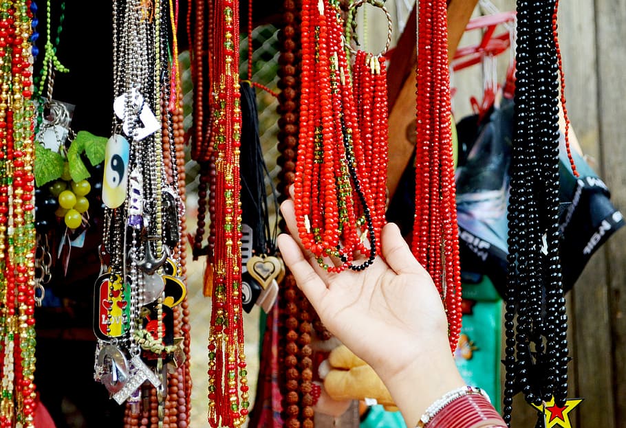 person holding beaded necklaces, beads, market, worship, jewelry