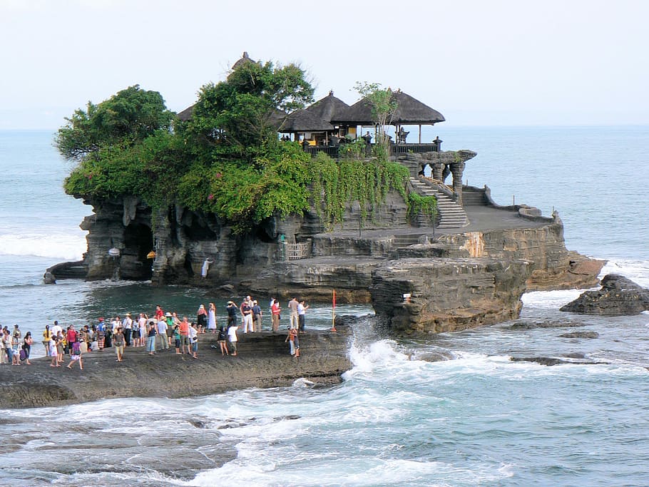 group of people on rock beside body of water, Bali, Temple, Tanah Lot