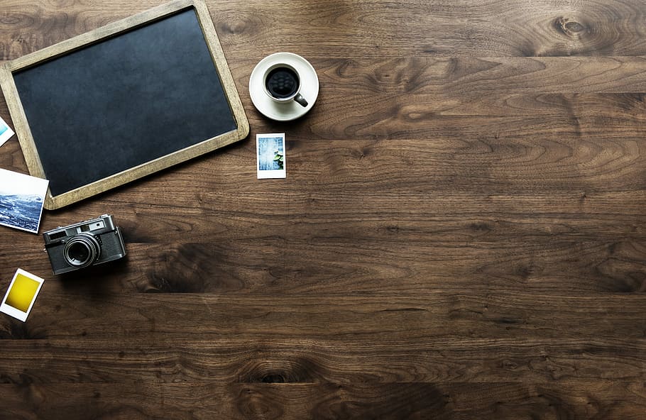 gray camera beside chalkboard and filled white ceramic teacup HD wallpaper