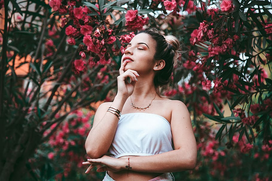 woman wearing tube top standing under flower during daytime, woman wearing white tube top near red petaled flowers HD wallpaper