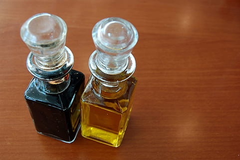 two clear glass bottles on brown surface, oil, vinegar, table HD wallpaper