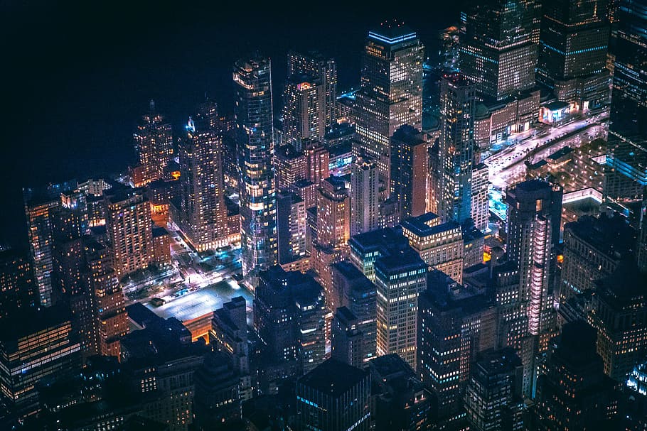 bird's eye view of city, timelapse photography of cars travelling surround by high-rise buildings during nighttime