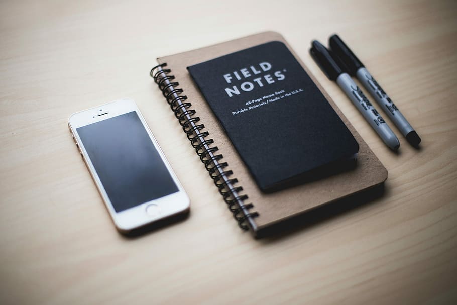 gold iPhone 5s with notebook, and two marker pens, technology HD wallpaper