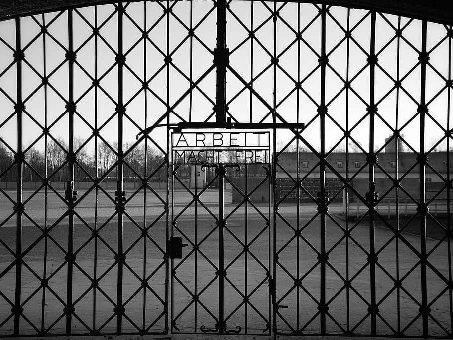 grayscale photo of Arbeit Macht Fre gate, dachau, bavaria, germany