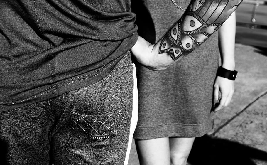 Young edgy white couple covered in full body tattoos posing with tough  scowl  Free Photo 426ry4  Noun Project