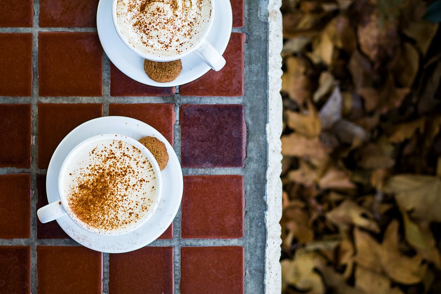 two cup of coffee on table top, flat lay photography of two mugs on brown tile flooring HD wallpaper