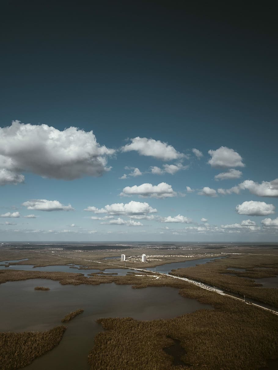 aerial view of body of water under gray sky during daytime, aerial photography of building surrounded with swamps HD wallpaper