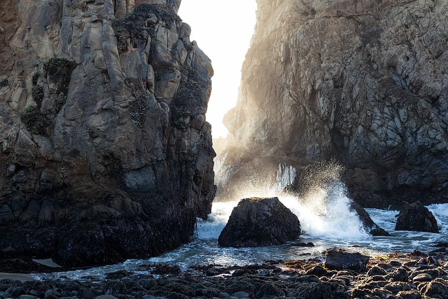 time lapse photography of body of water between cliffs, rock formations surrounded by water HD wallpaper
