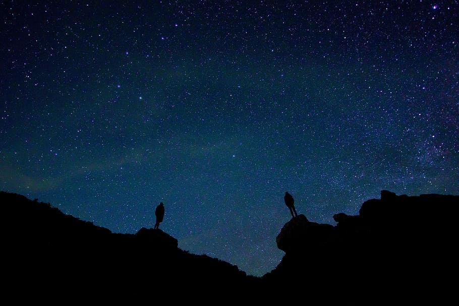 two person standing on rock under starry night silhouette photograph HD wallpaper