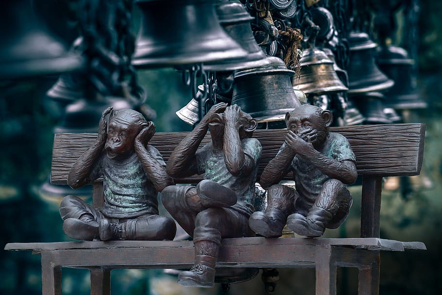 Three Wise Monkeys on brown wooden bench, bells, noise, crash