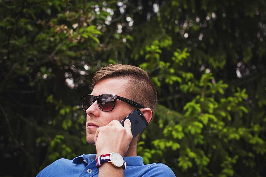 selective focus photography of man holding iPhone, calling HD wallpaper