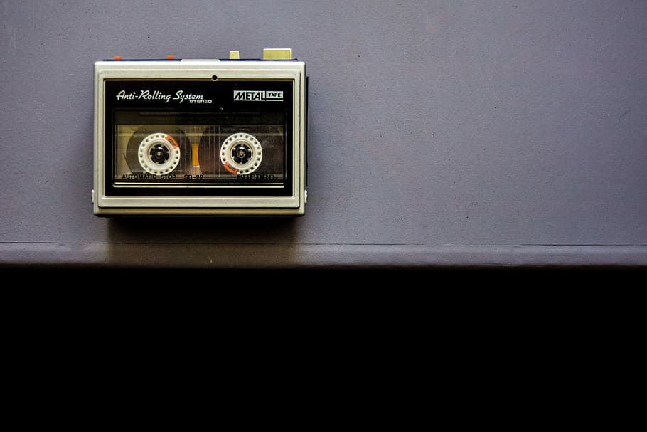 black and white cassette on gray wall, tape, music, walkman, object