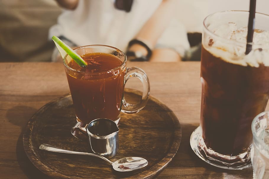 clear glass mug filled with brown liquid, stainless steel spoon near glass mug HD wallpaper