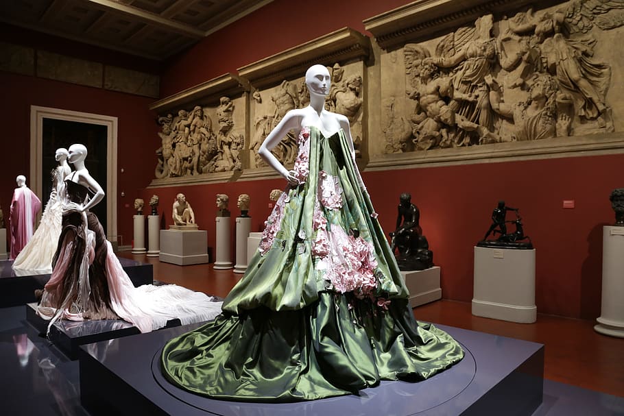 women's green and red floral dress in mannequin, theatre, museum